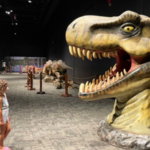a picture of a little girl staring up at a dinosaur in the museum