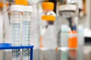 Diverse students in lab coats collaborating on research