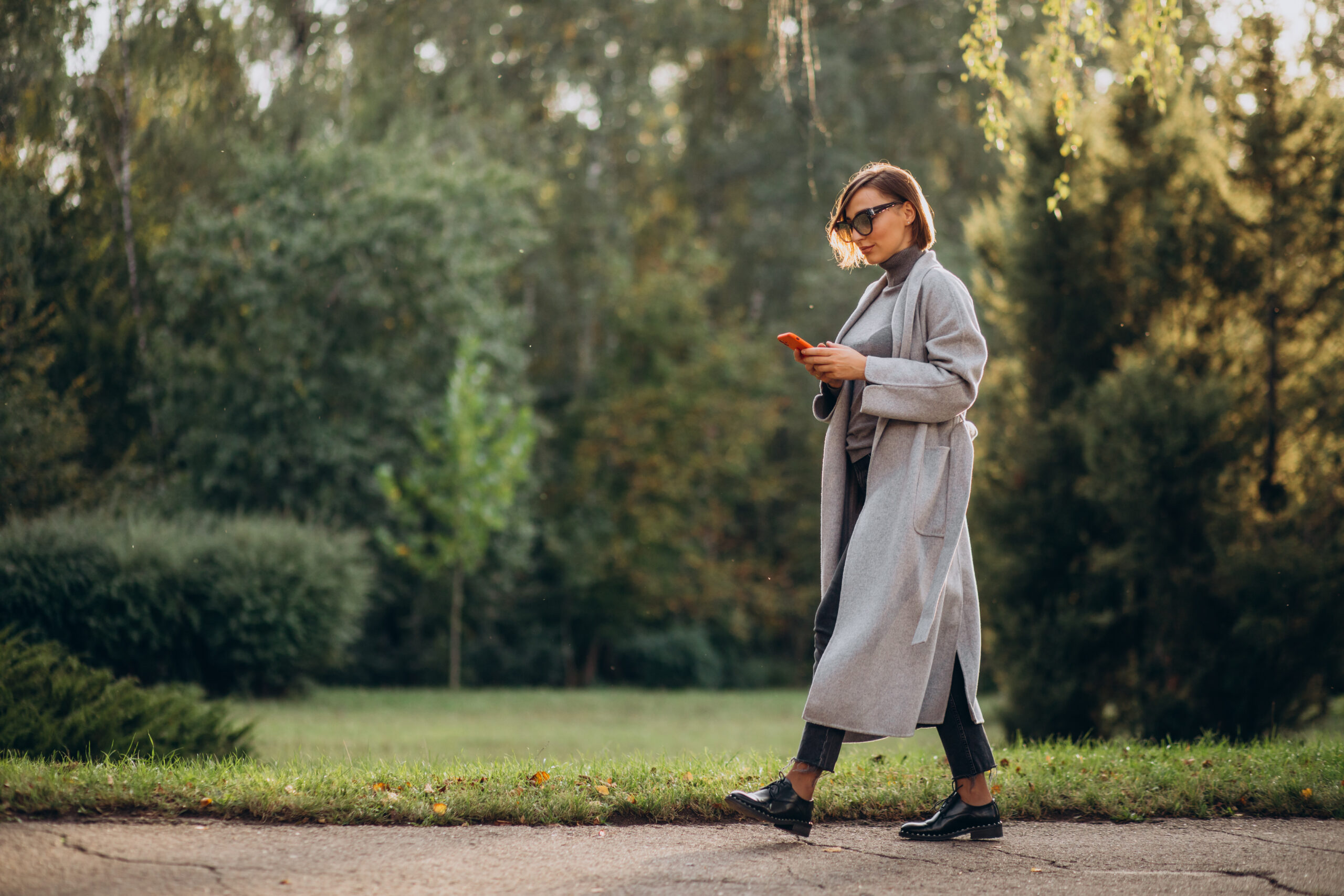 Woman walking through a park in British Columbia, symbolizing local charities promoting mental health and outdoor wellness.