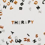 The word therapy spelled with colorful letters on a white background representing mental health support in Ontario