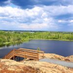 Overlook of a lake and forest landscape in Manitoba symbolizing healing, reflection, and community rooted care
