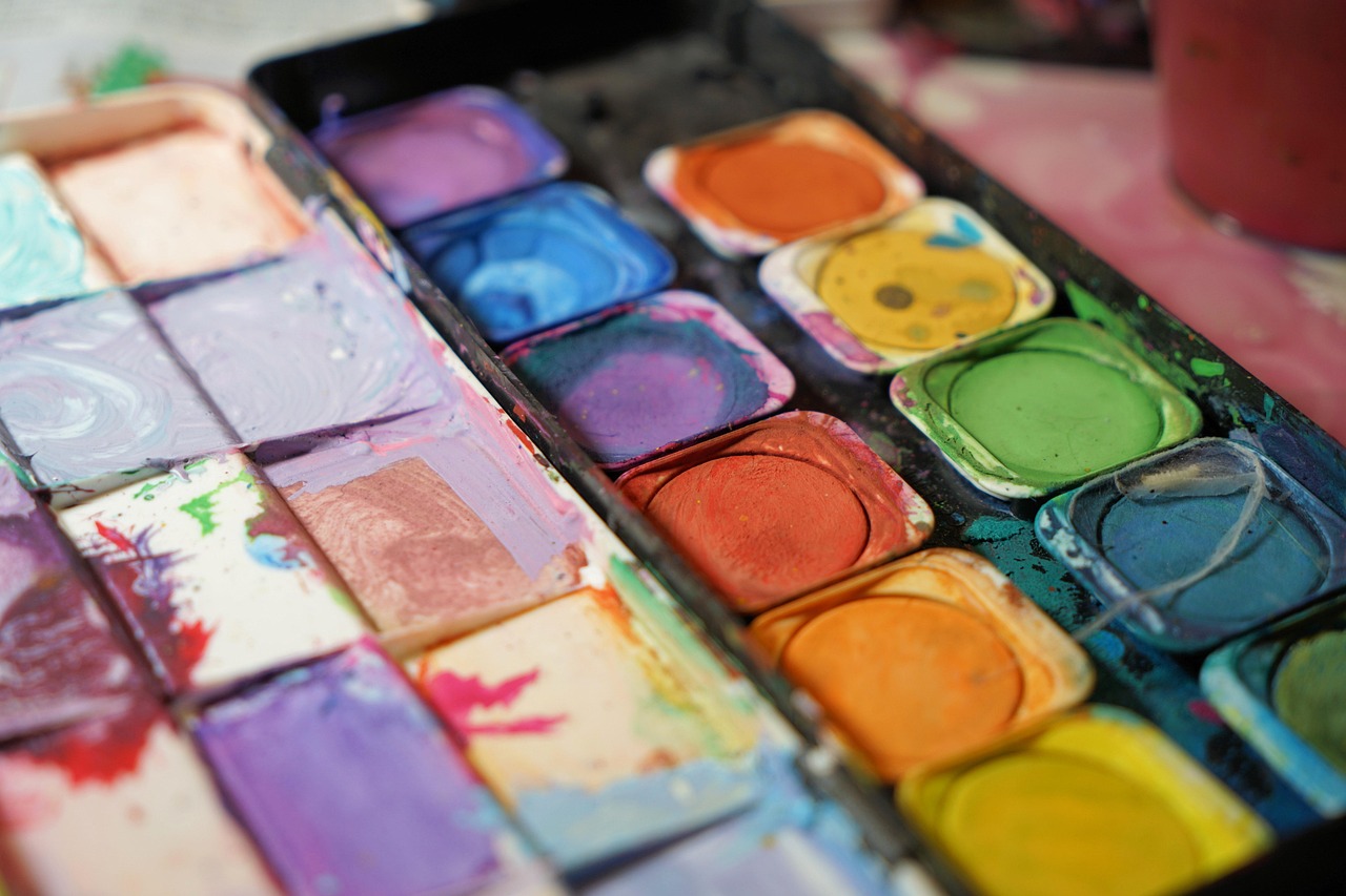 Watercolor paint palette with vibrant colours used in youth art therapy sessions