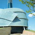 Canadian Museum for Human Rights in Winnipeg, Manitoba, featuring its distinctive architecture under a bright blue sky.