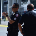 Police officers speaking with a woman at a road incident scene during an impaired driving investigation in Canada.
