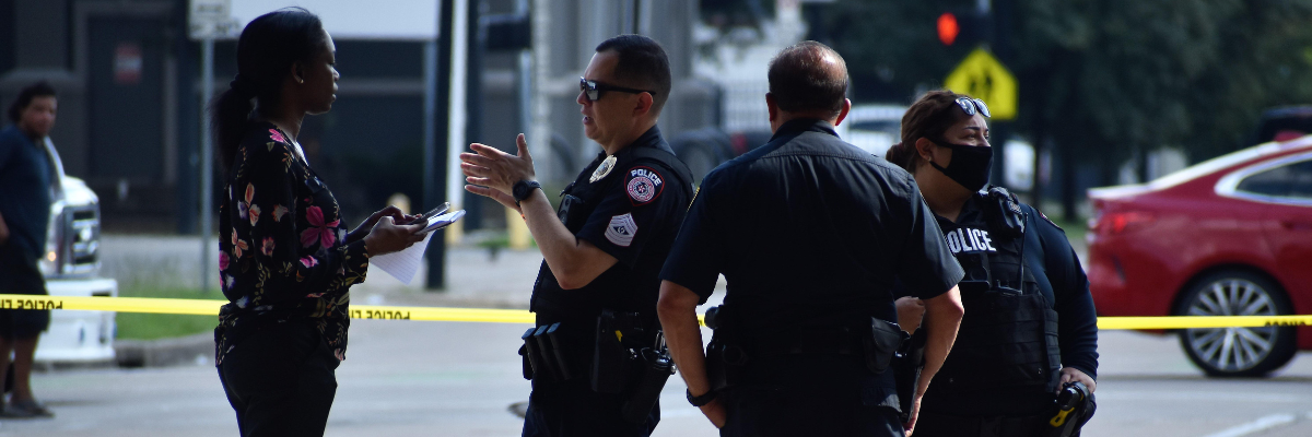 Police officers speaking with a woman at a road incident scene during an impaired driving investigation in Canada.